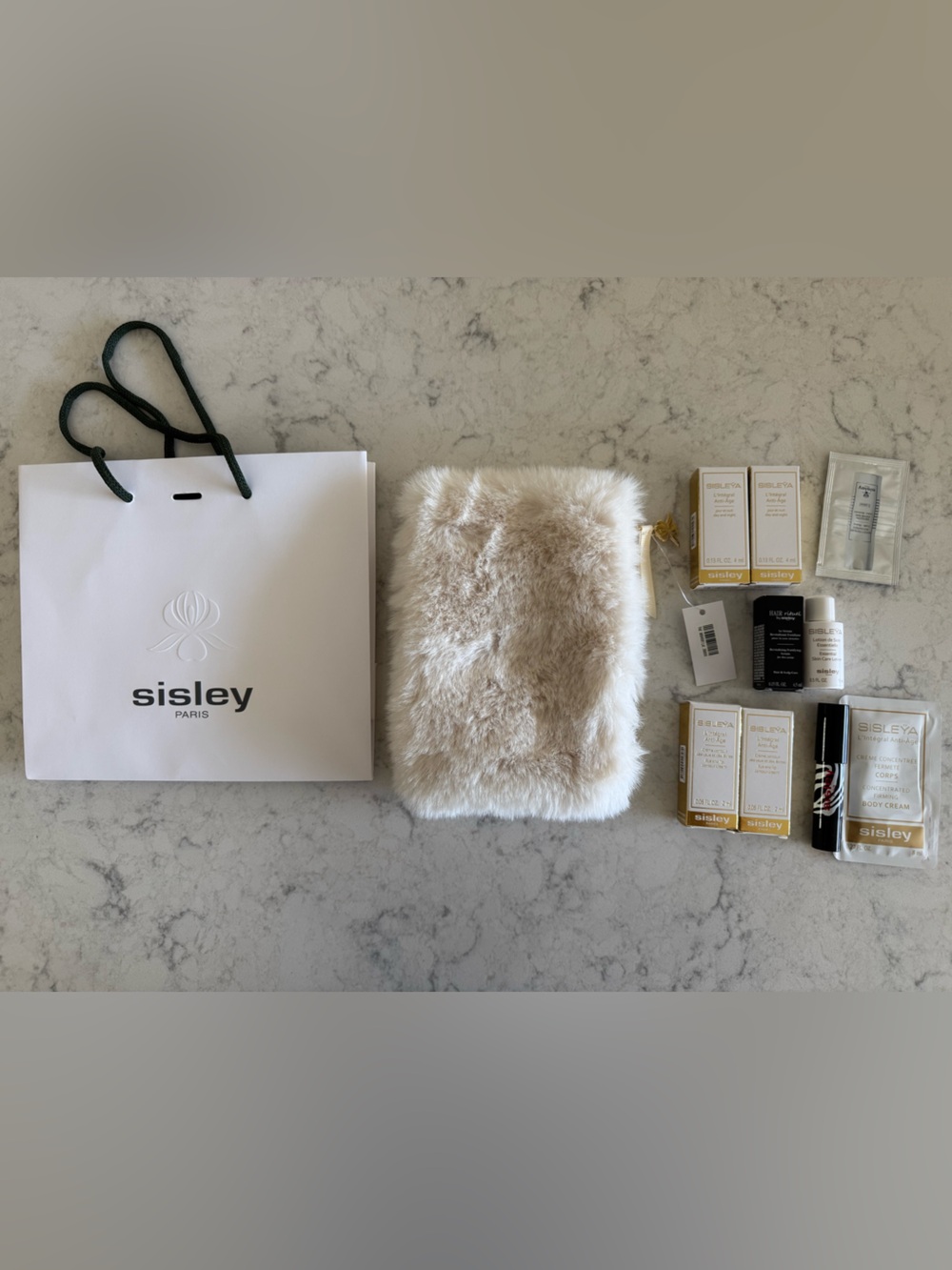 Sisley-Paris Cream Faux Fur Zip Pouch with many samples